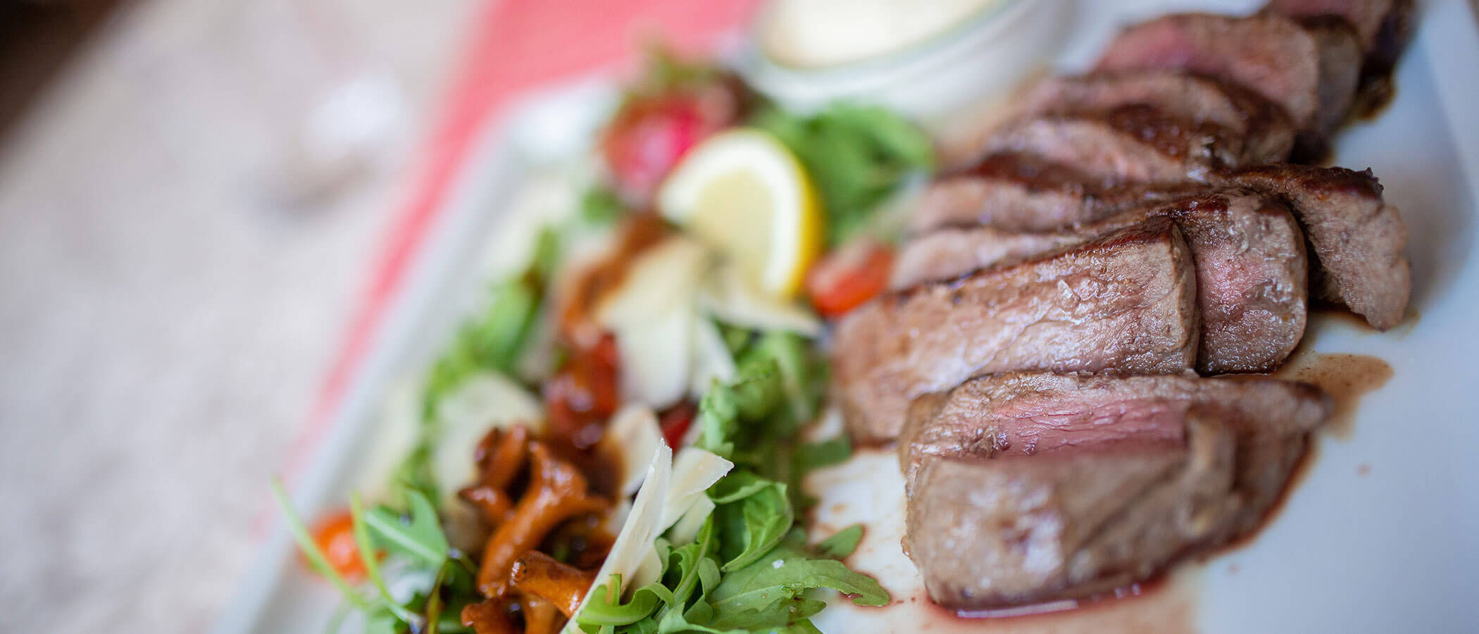 Indulgence - meat with salad & mushrooms on a plate - Hotel Amaten